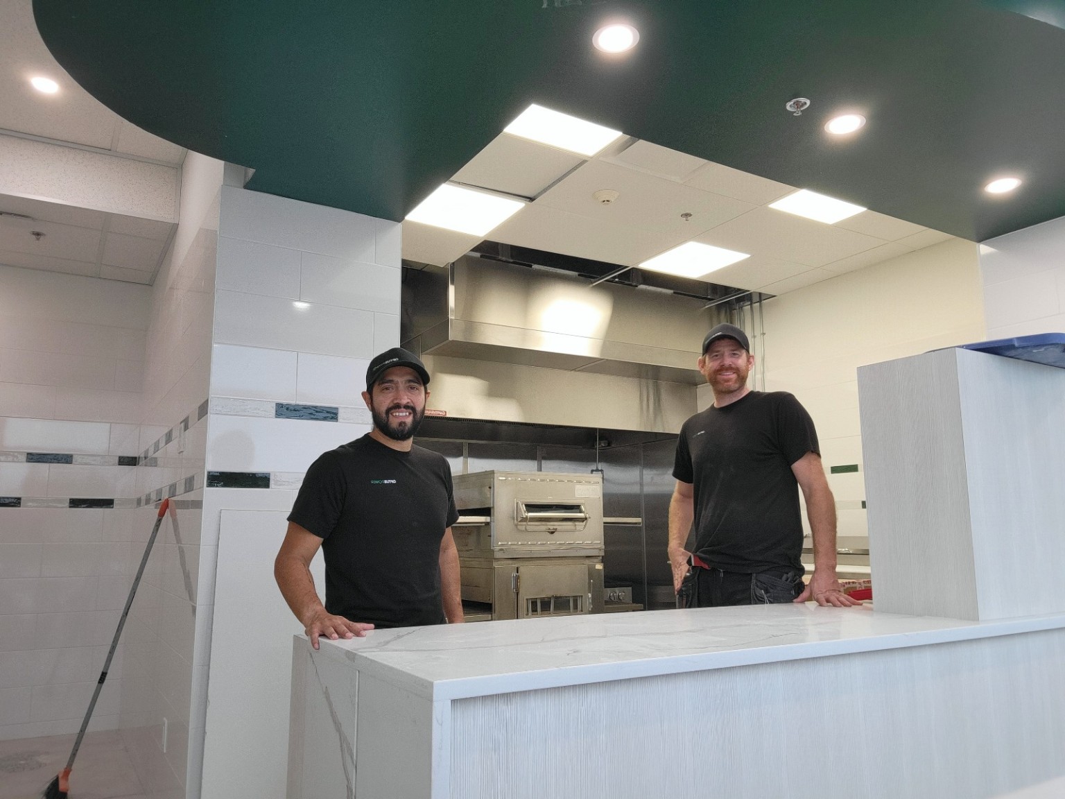 Optus Power team at a commercial counter with ceiling lighting
