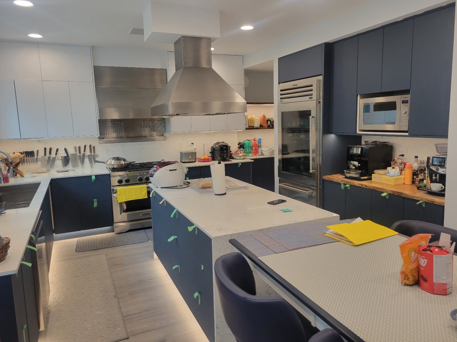 Kitchen with blue cabinetry, recessed ceiling lights and under-cabinet lighting